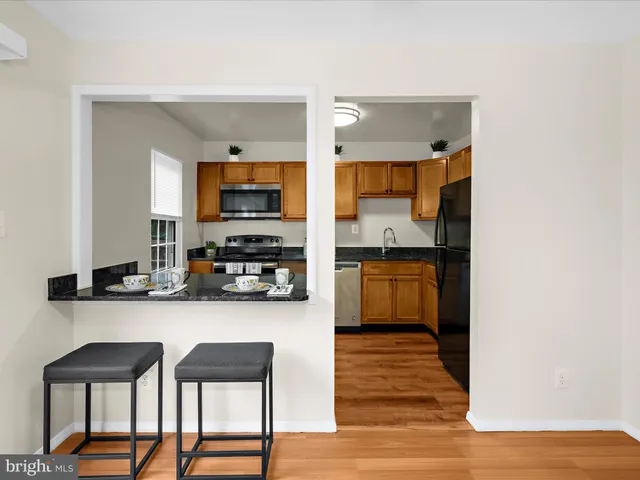 a kitchen with stainless steel appliances a stove and cabinets