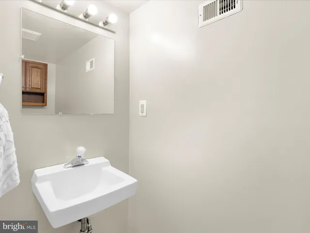 a bathroom with a sink a mirror and vanity