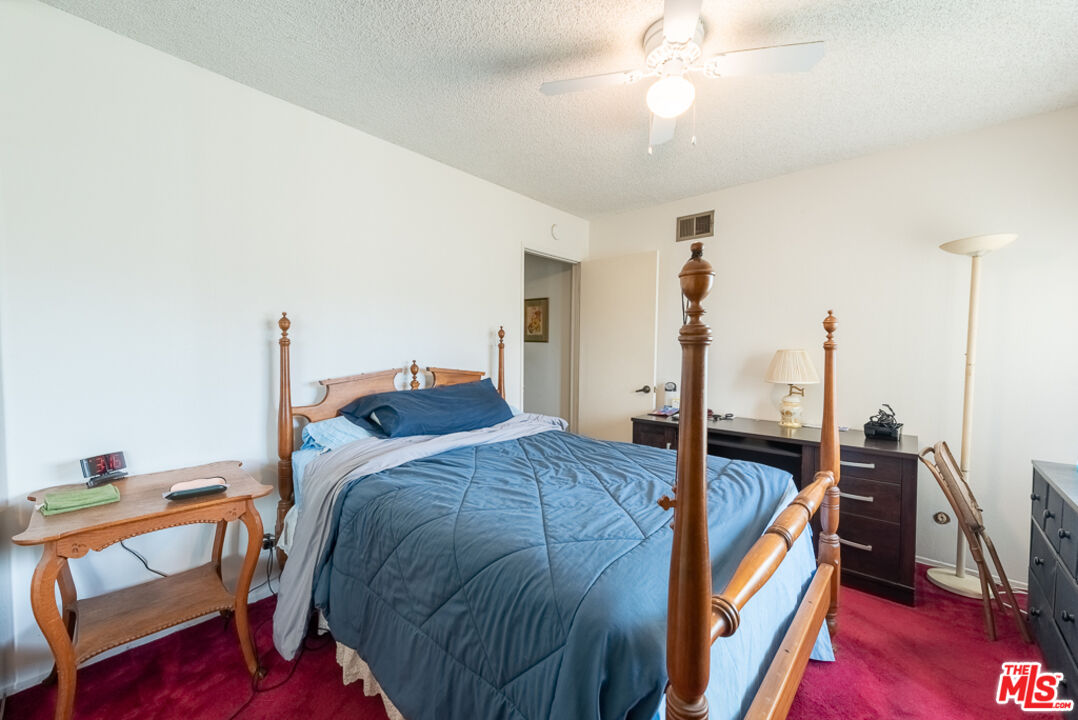 1637 Downing Street Simi Valley, CA 93065 - Photo 9 of 26 a bed room with a bed and a chandelier