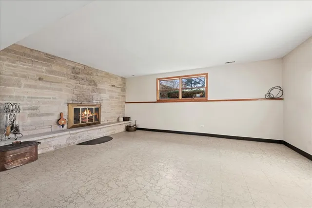 a view of a livingroom with an empty space and a fireplace