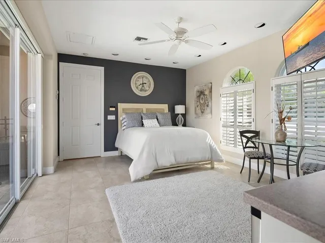 a bedroom with a bed and a table in it