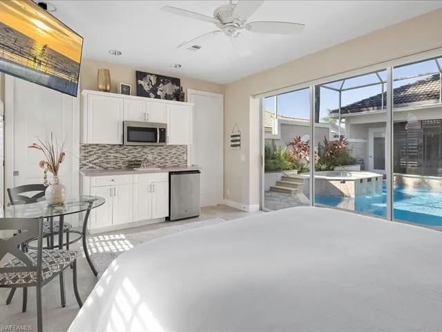 a living room with stainless steel appliances kitchen island granite countertop furniture and a kitchen view