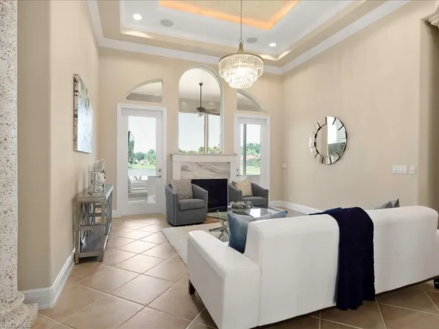 a living room with fireplace furniture and a large window
