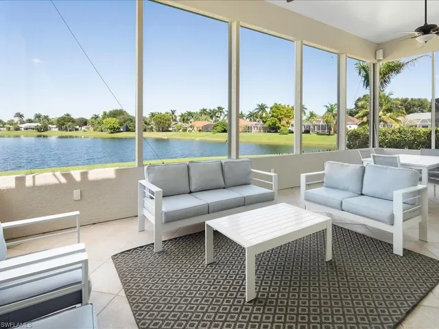 a living room with furniture city view and large windows
