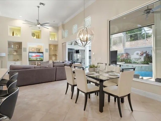 a view of a dining room with furniture large windows and wooden floor