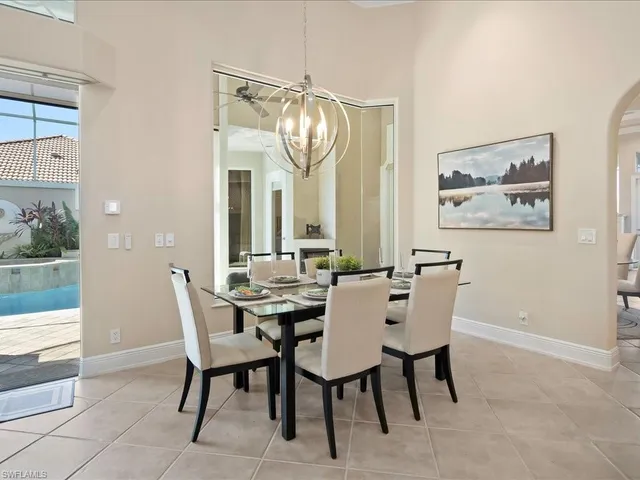 a view of a dining room with furniture and chandelier