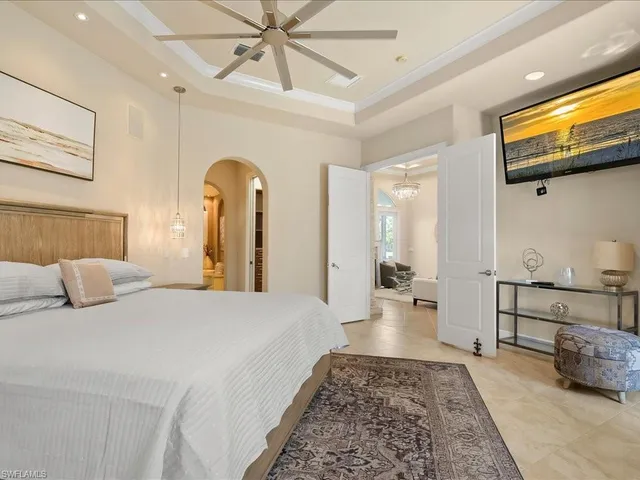 a bedroom with a bed and ceiling fan