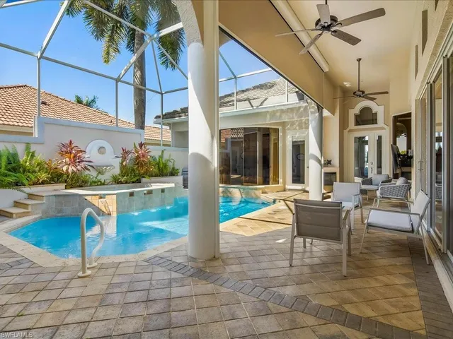 a view of a patio with swimming pool table and chairs