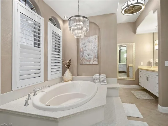 a spacious bathroom with sinks mirror and a bathtub