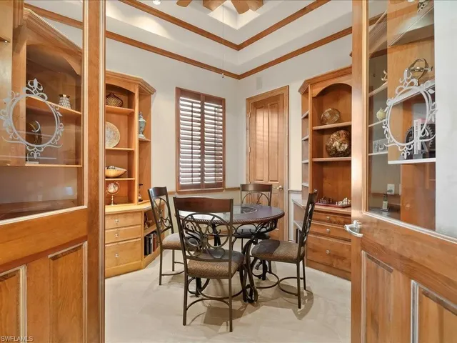 a view of a dining room with furniture and chandelier