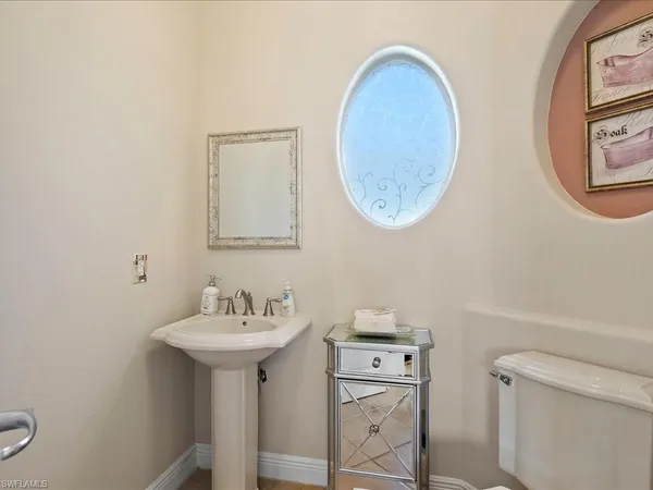 a bathroom with a toilet a sink and a mirror
