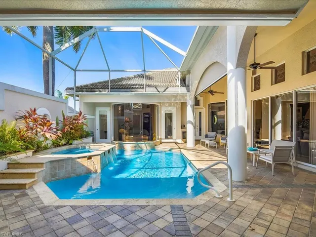 a view of a house with swimming pool and sitting area