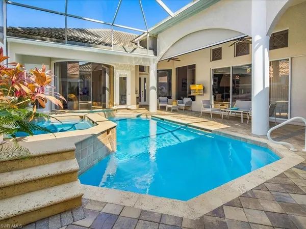 a view of a house with swimming pool and sitting area