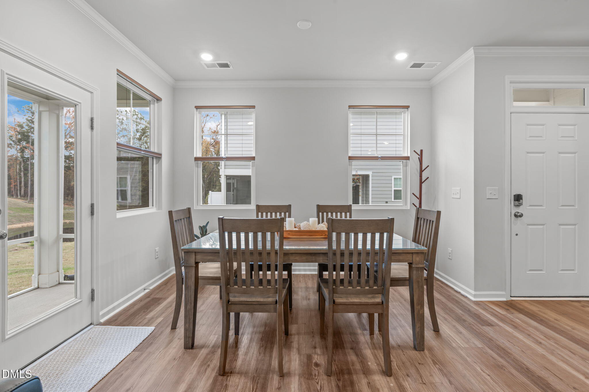 1809 Barrett Run Trail Apex, NC 27502 - Photo 13 of 37 a view of a dining room with furniture and wooden floor