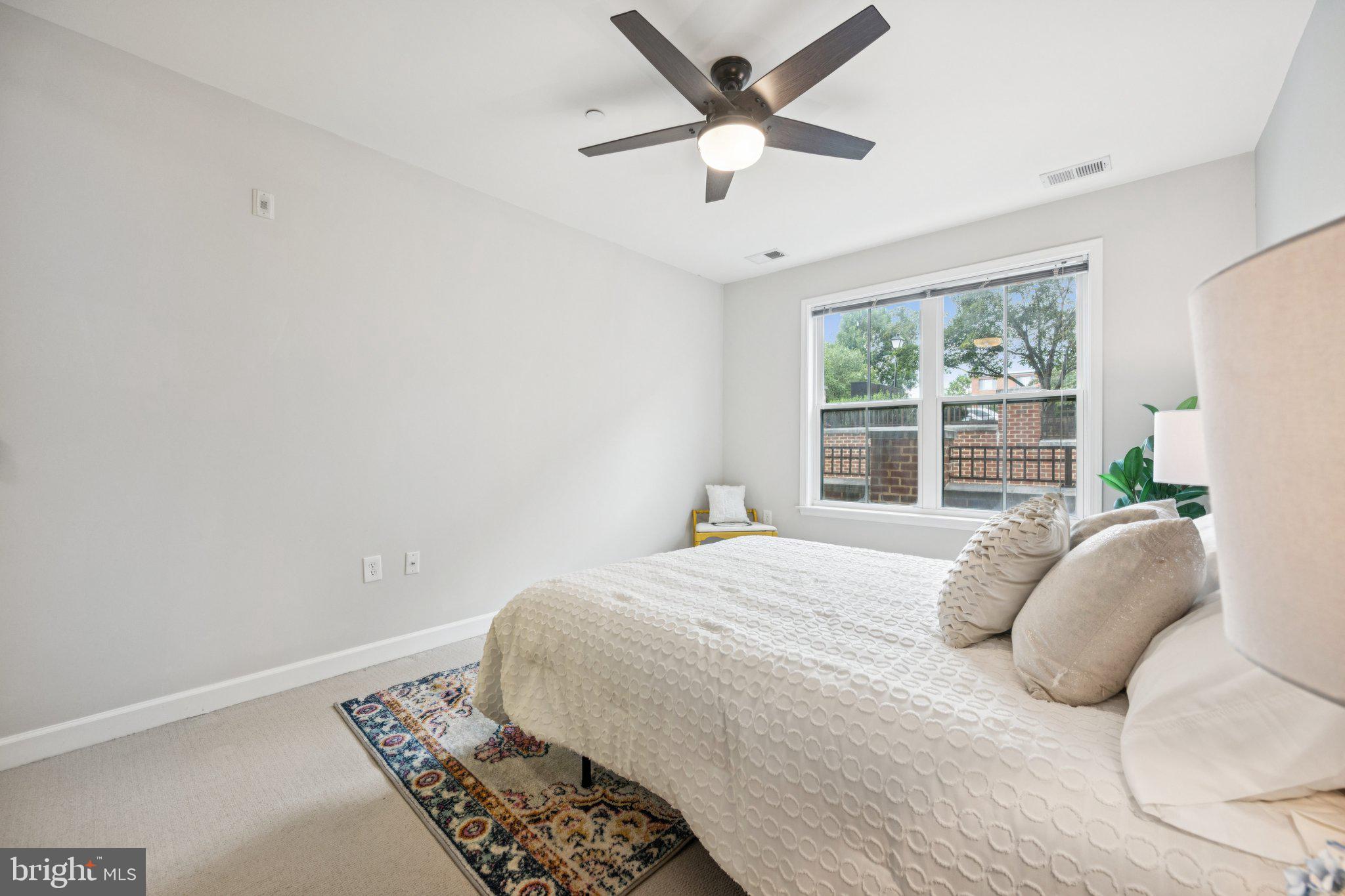 2101 North Monroe Street, Unit 107 Arlington, VA 22207 - Photo 14 of 24 a bedroom with a large bed and a window