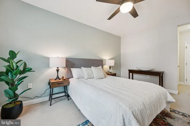 a bathroom with a granite countertop sink a toilet and a mirror