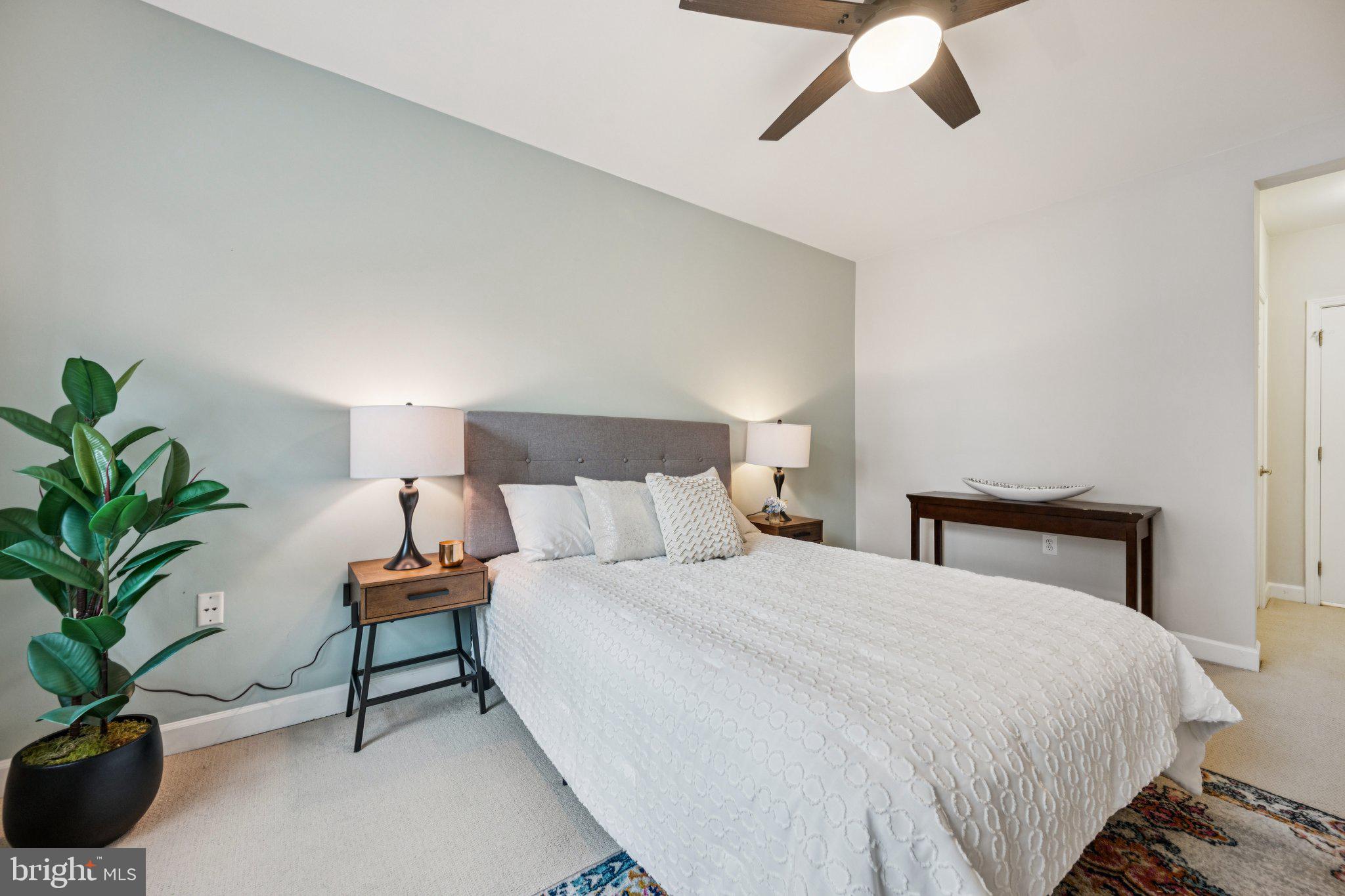 2101 North Monroe Street, Unit 107 Arlington, VA 22207 - Photo 15 of 24 a bedroom with a bed and a potted plant