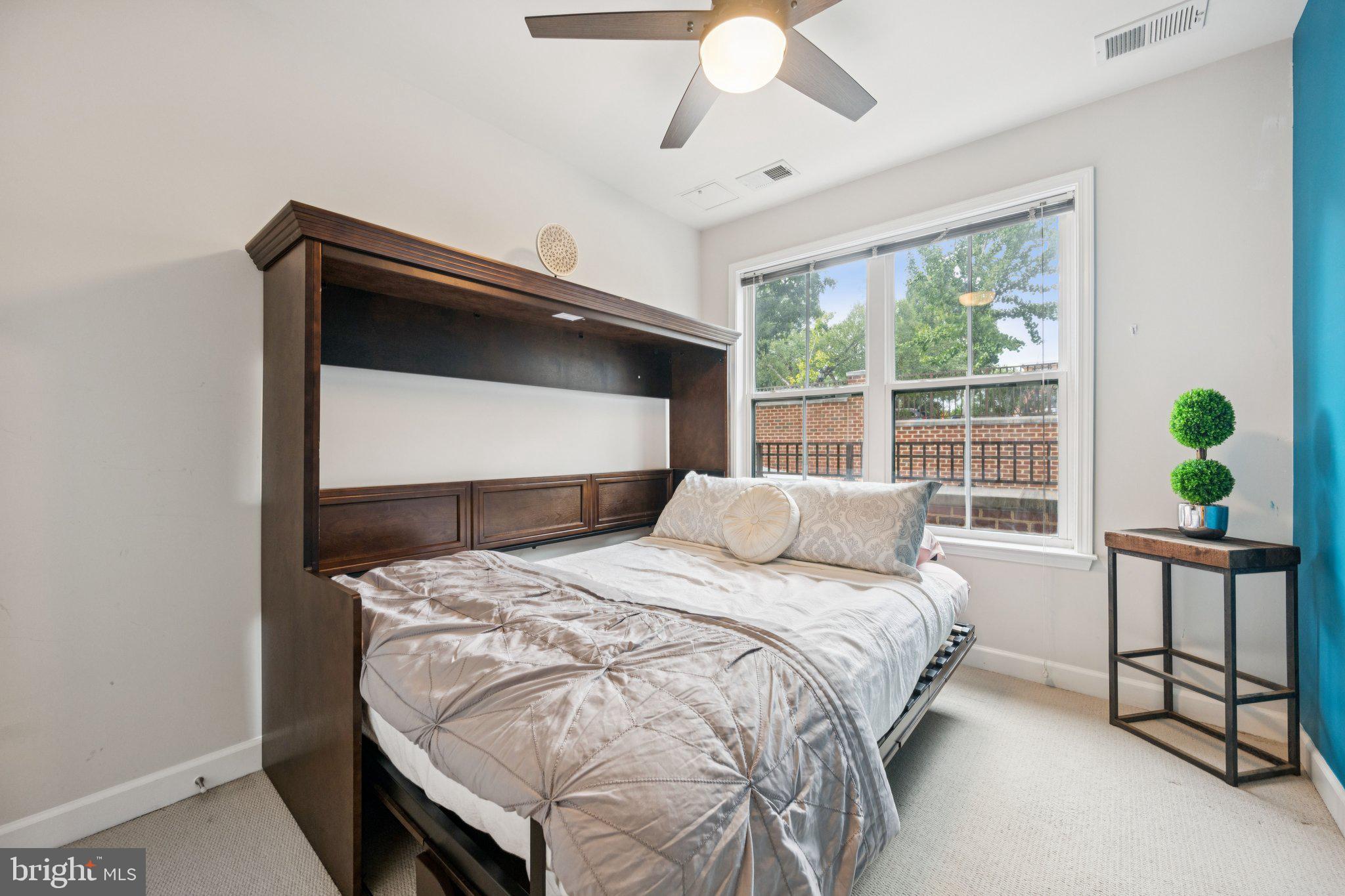 2101 North Monroe Street, Unit 107 Arlington, VA 22207 - Photo 19 of 24 a bedroom with a bed and a window