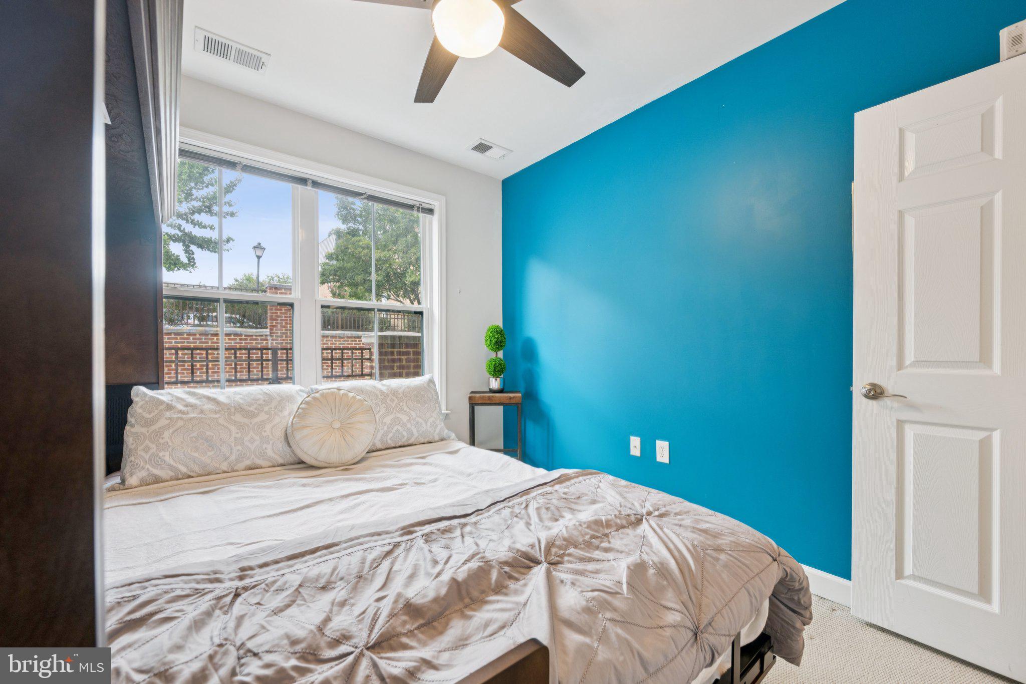 2101 North Monroe Street, Unit 107 Arlington, VA 22207 - Photo 21 of 24 a bedroom with a large bed and a window