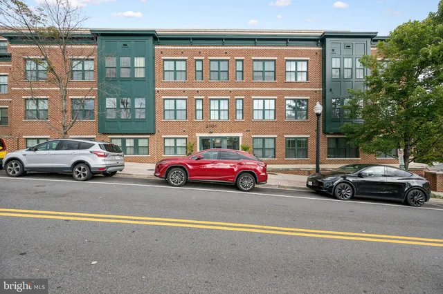 a kitchen with granite countertop wooden floors and stainless steel appliances