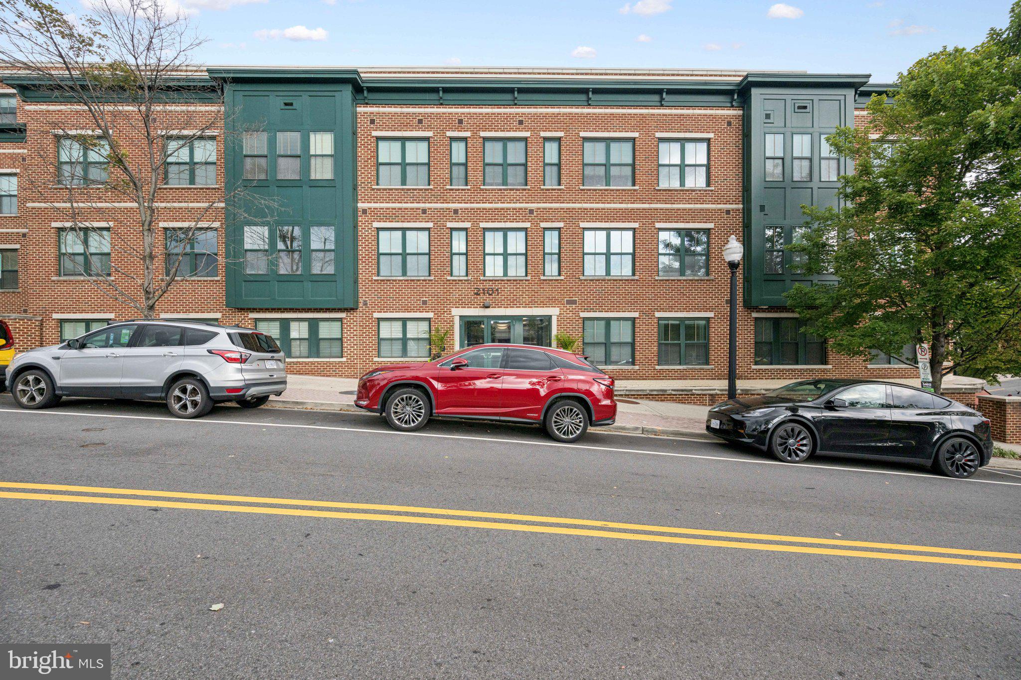 2101 North Monroe Street, Unit 107 Arlington, VA 22207 - Photo 3 of 24 a view of a cars parked in front of a building