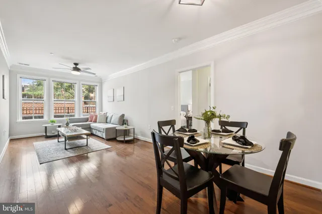 a view of a dining room with furniture and wooden floor