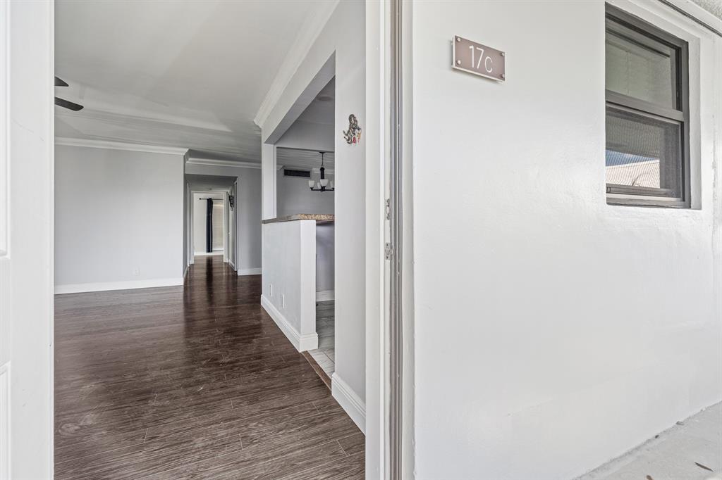 502 Osprey Drive, Unit 17C Delray Beach, FL 33444 - Photo 3 of 41 a view of a hallway with wooden floor and a cabinet