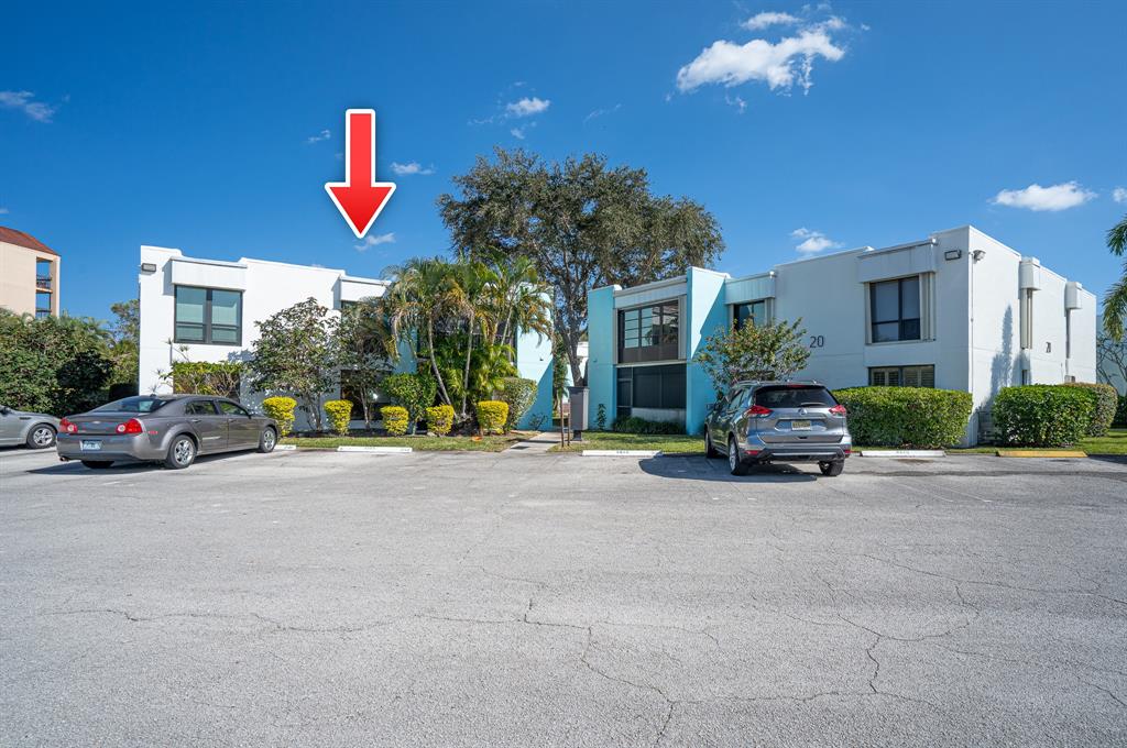 502 Osprey Drive, Unit 17C Delray Beach, FL 33444 - Photo 39 of 41 a view of car parked in front of a building