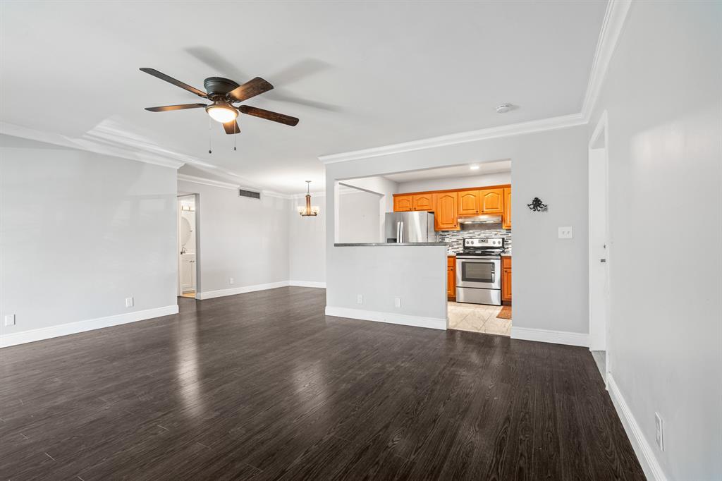 502 Osprey Drive, Unit 17C Delray Beach, FL 33444 - Photo 5 of 41 a view of a kitchen with wooden floor and a ceiling fan