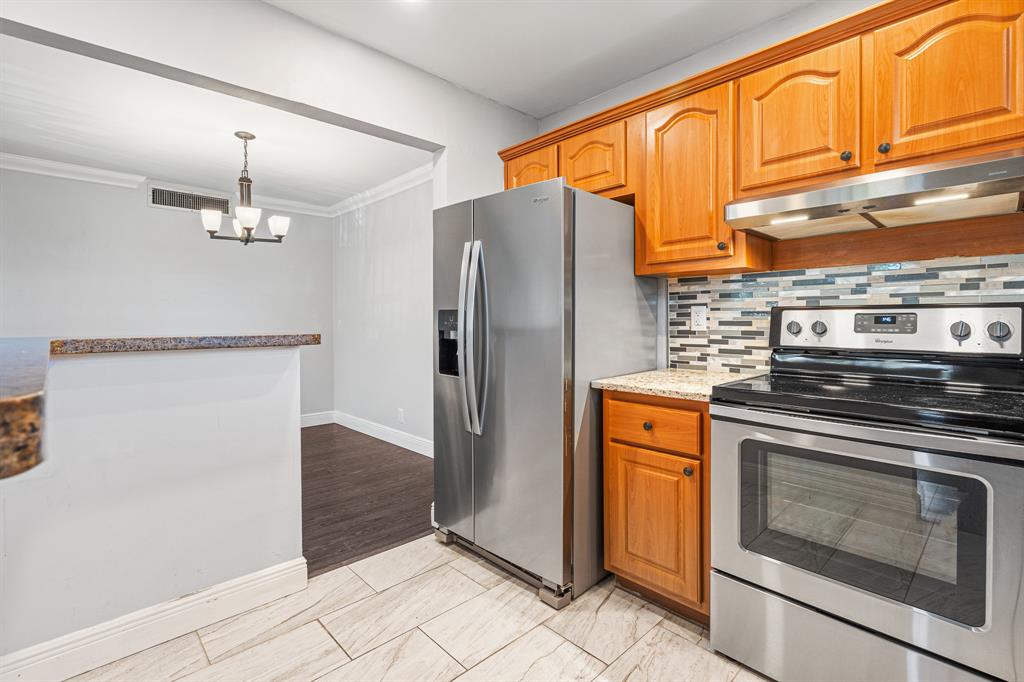 502 Osprey Drive, Unit 17C Delray Beach, FL 33444 - Photo 10 of 41 a kitchen with stainless steel appliances granite countertop a refrigerator and a stove top oven