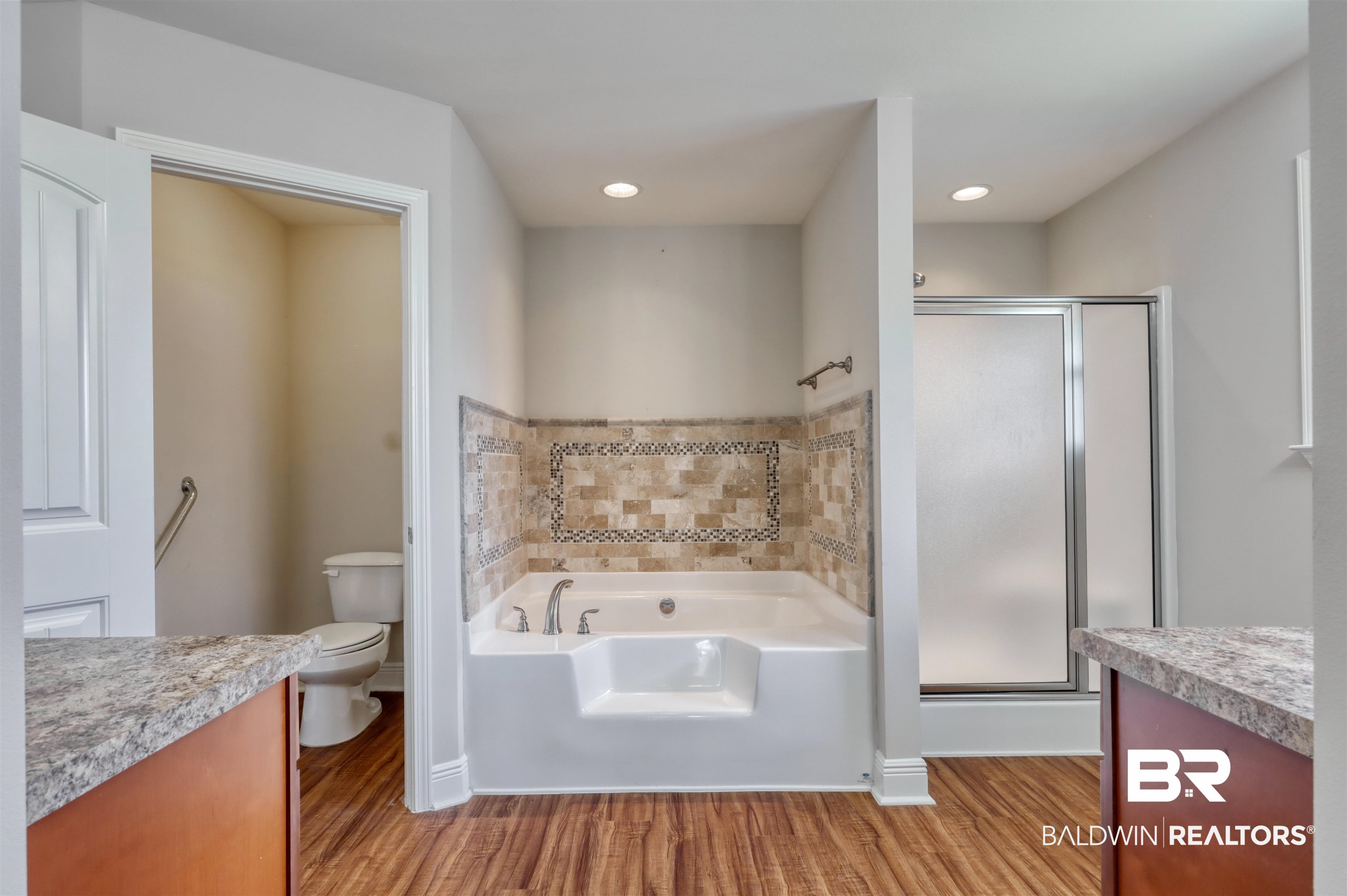 14794 Troon Drive Foley, AL 36535 - Photo 16 of 33 Full bath featuring a garden tub, a stall shower, toilet, and wood finished floors