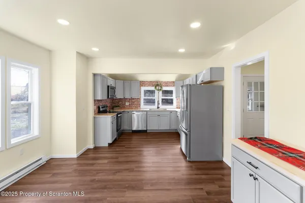 a kitchen with a refrigerator and cabinets