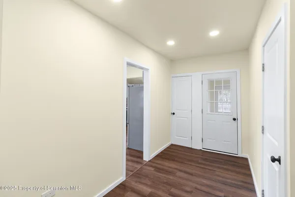 a view of hallway with wooden floor