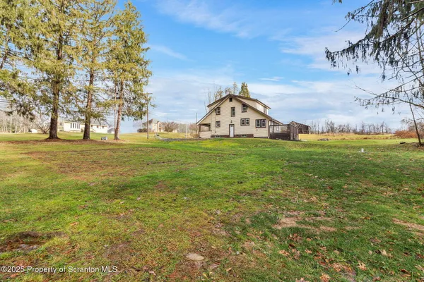 a view of a field with a building in the background