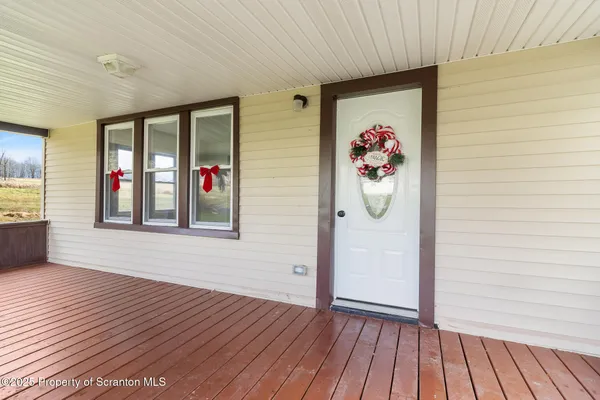 a view of an entryway with wooden floor