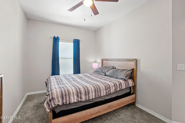 a bedroom with a bed dresser and a window