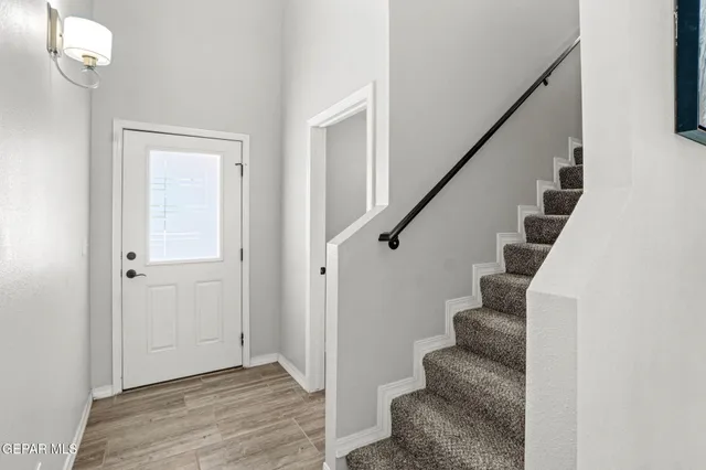 a view of entryway with wooden floor and stairs