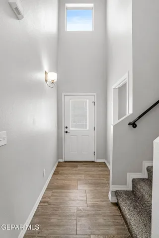 a view of a livingroom with wooden floor and staircase