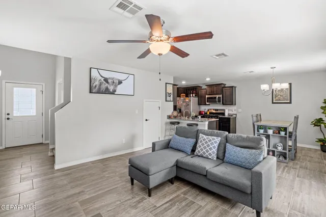 a living room with furniture and kitchen view