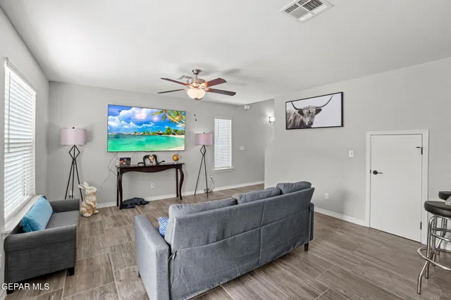 a living room with furniture and a flat screen tv