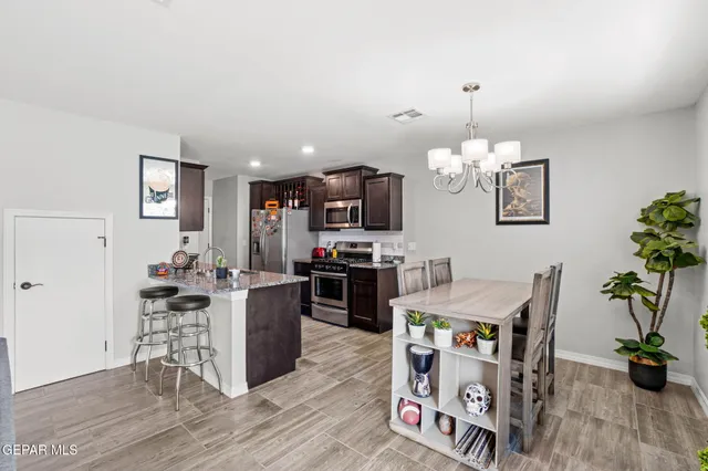 a kitchen with a refrigerator and a stove top oven