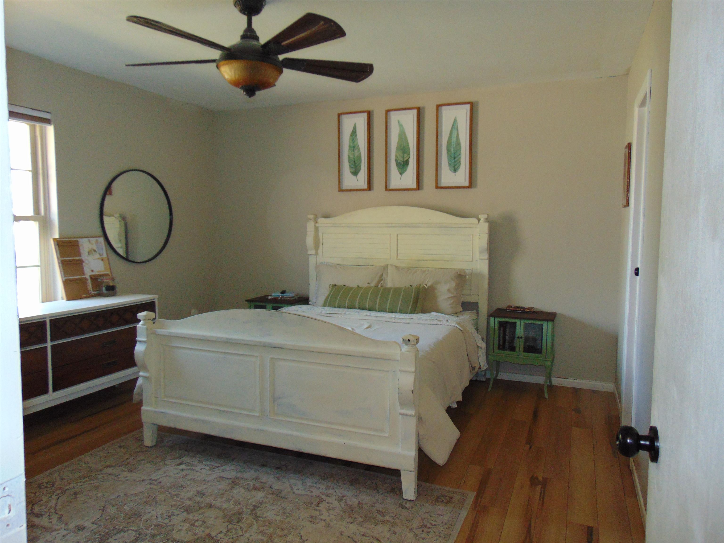 321 North Ash Street Fruita, CO 81521 - Photo 12 of 24 a bedroom with a bed and a chandelier