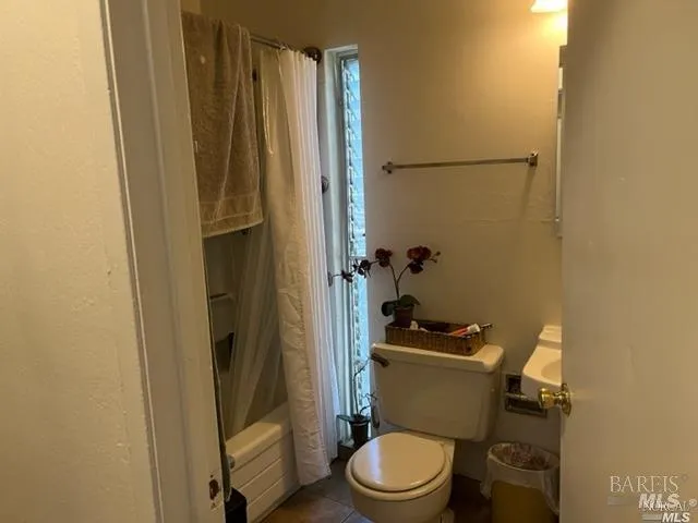 a white toilet sitting next to a small sink