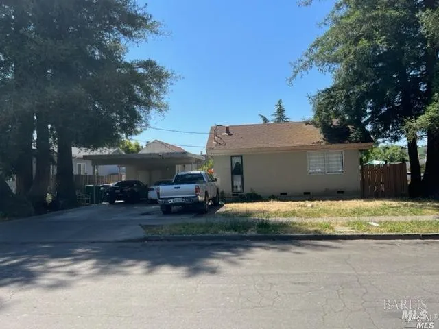 a house that has a tree in front of it