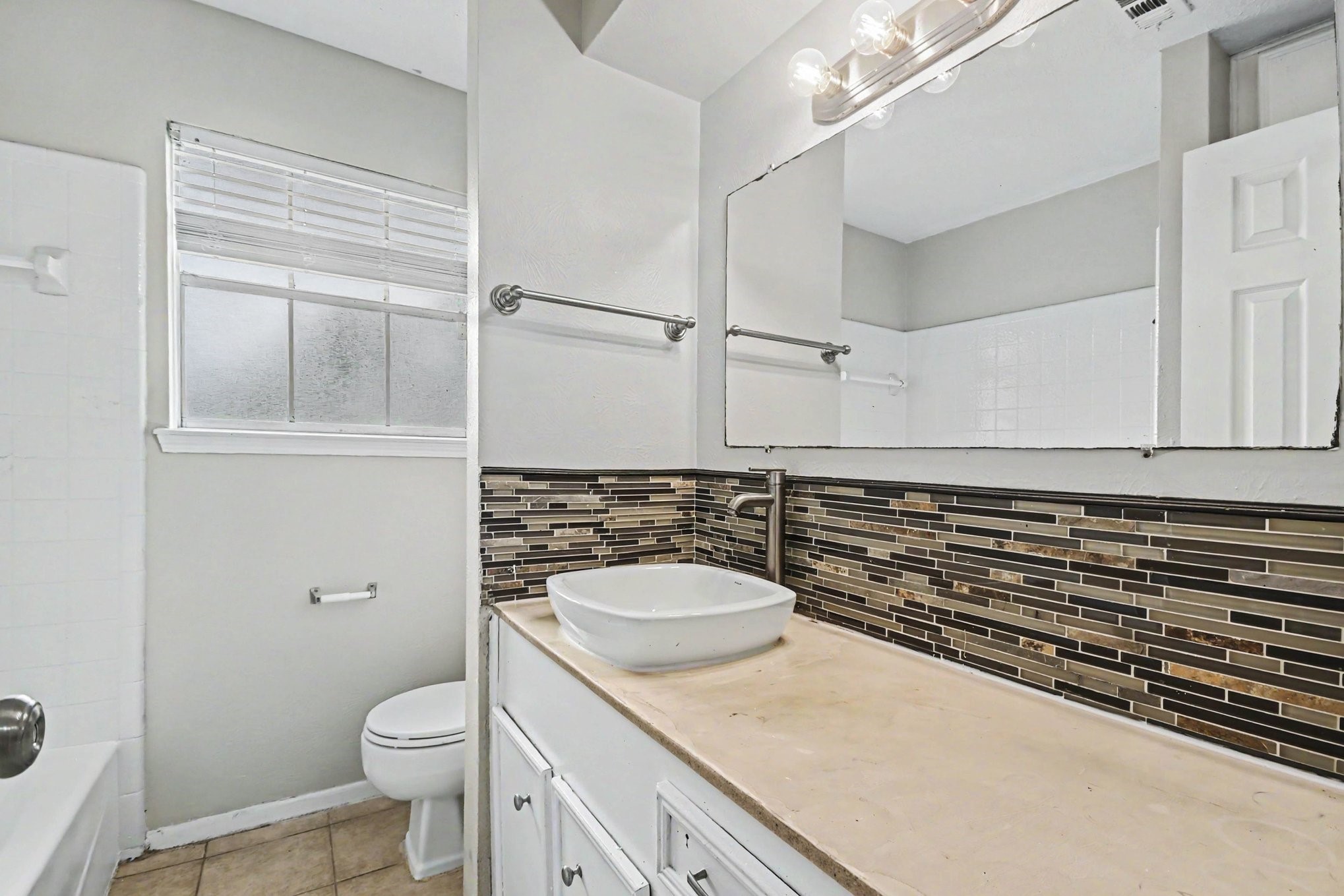 4306 Oneida Street Pasadena, TX 77504 - Photo 18 of 23 a bathroom with a granite countertop sink toilet and mirror
