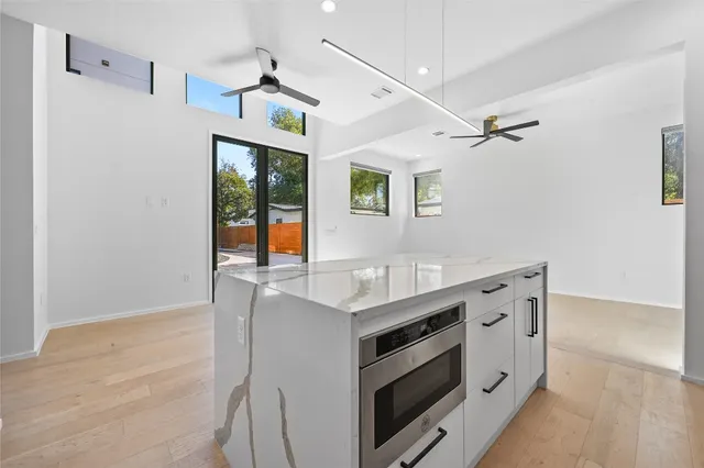 a kitchen with stainless steel appliances a sink stove and cabinets