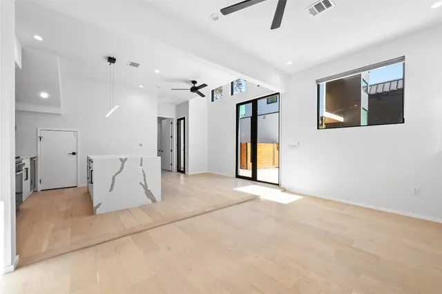 a view of a kitchen with a sink and a refrigerator