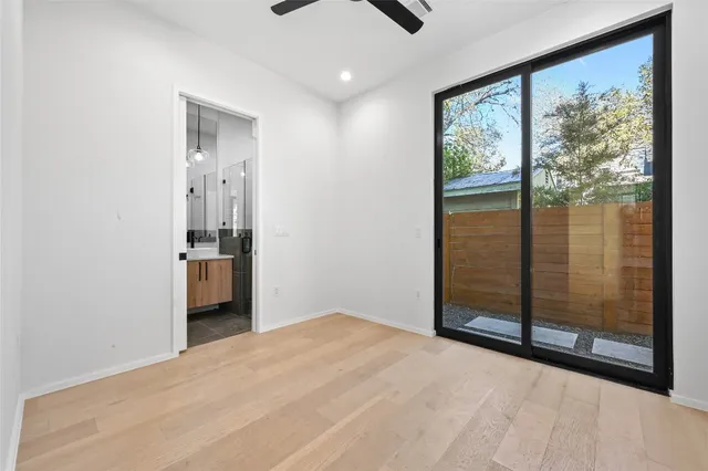 a view of hallway with a large window and chandelier