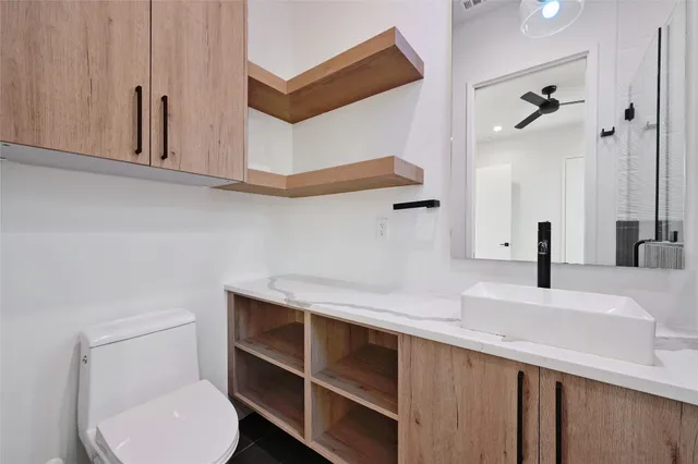 a bathroom with a sink a toilet and mirror