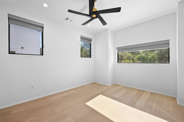 a view of a room with wooden floor and windows